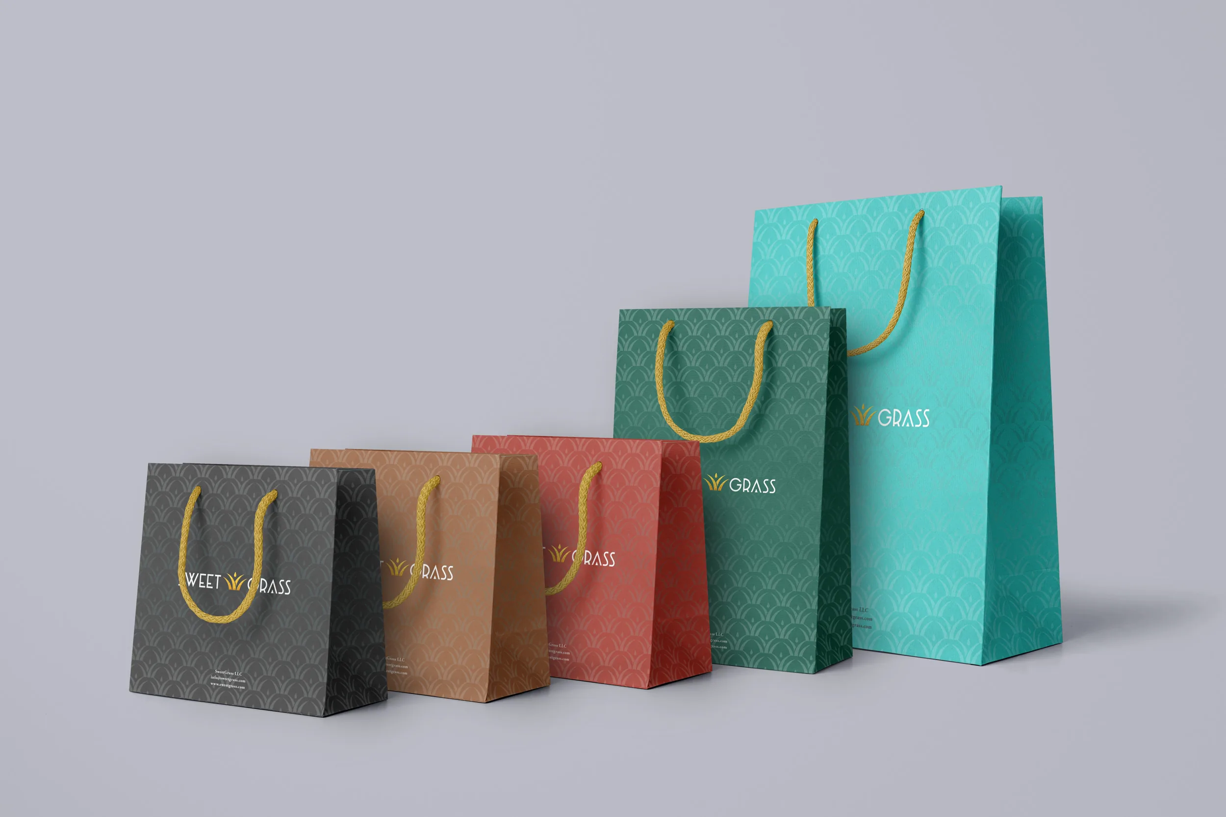 SweetGrass retail bags in five brand colors with a gold scallop pattern and wordmark